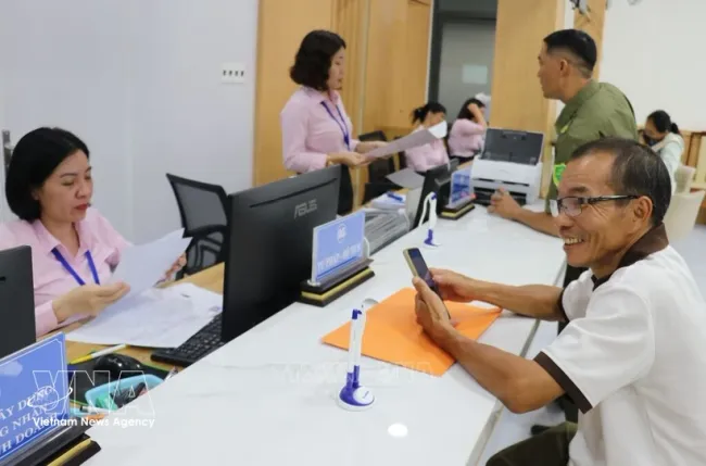 Civil servants at the Dong Xoai ward Public Administration Service Centre handle administrative procedures for local residents. (Photo: VNA)