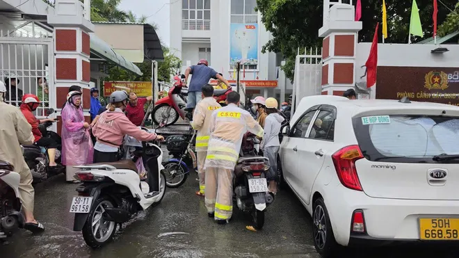 CSGT dùng xe đặc chủng chở dân qua đường ngập ở TP Hồ Chí Minh - Ảnh 4.
