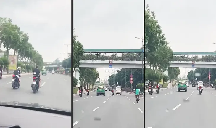 Hai thanh niên nằm trên xe máy, chạy tốc độ cao trên đường TP Hồ Chí Minh - Ảnh 1. Hai thanh niên nằm trên xe máy, chạy tốc độ cao trên đường TP Hồ Chí Minh - Ảnh 1.