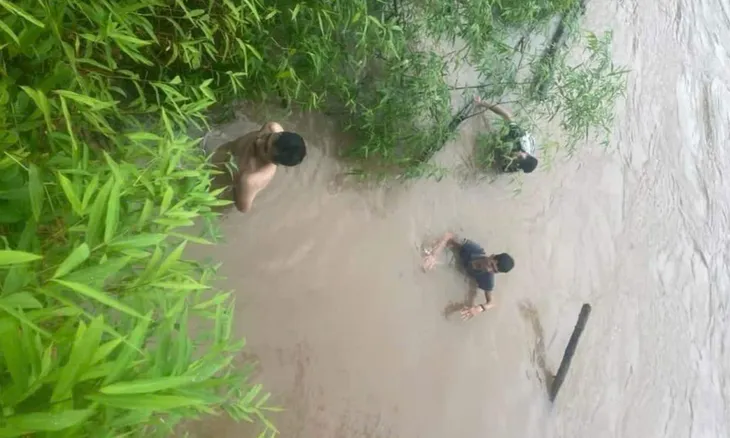 Xe đầu kéo bị lũ cuốn trôi, người dân lao xuống dòng nước cứu tài xế - Ảnh 2. Xe đầu kéo bị lũ cuốn trôi, người dân lao xuống dòng nước cứu tài xế - Ảnh 2.