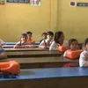 Students cross river to school during flood season