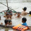 Coach trains kids to swim before the flood season