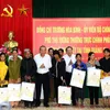 Officials present Tet gifts to poor people, disadvantaged children