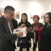 Exhibition features photos and sculptures about Vietnam