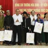 Officials present Tet gifts to poor people, disadvantaged children