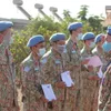 Vietnamese green beret medics salute national flag in South Sudan