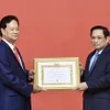 Former Prime Minister presented with 55-year Party membership badge