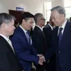 President To Lam meets Vietnamese people in Laos