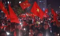 Vietnamese football fans flock to the streets to celebrate Vietnam's football team victory