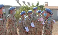 Vietnamese green beret medics salute national flag in South Sudan