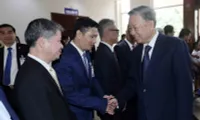 President To Lam meets Vietnamese people in Laos