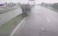 Phóng nhanh dưới trời mưa, xe tải lên dải phân cách giữa đường