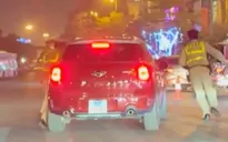 Tạm giữ lái xe hất Cảnh sát giao thông lên nóc capo rồi bỏ chạy