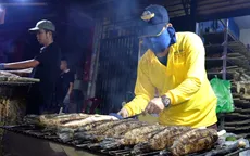 "Phố cá lóc nướng" ở TP Hồ Chí Minh rực lửa xuyên đêm ngày vía Thần Tài