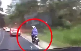 Xe máy ôm cua trượt ngã trước đầu ô tô