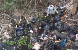 Thanh niên tình nguyện ngâm mình nhiều giờ dưới sông đen kịt để vớt rác