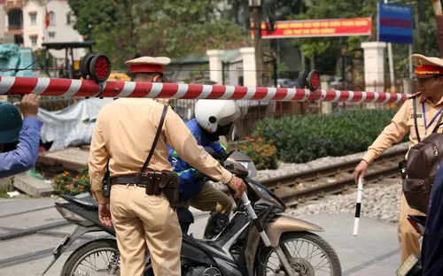 Bất chấp còi tàu và rào chắn, nhiều xe máy liều mình vượt đường sắt ở Ngọc Hồi