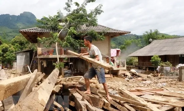 Residents in flooded areas battle debris