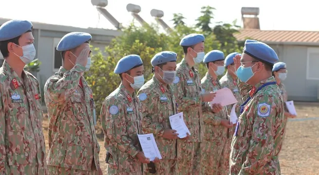 Vietnamese green beret medics salute national flag in South Sudan