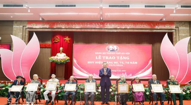 Party, State leader presents Party-membership badges to veteran members